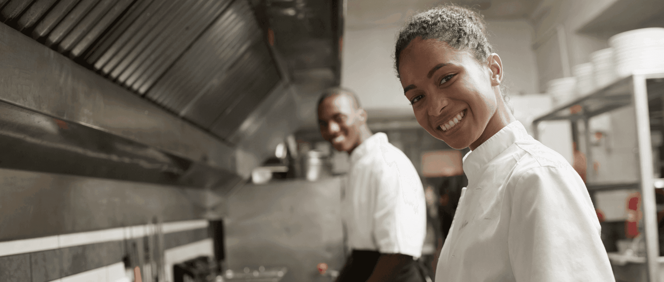 Two chefs in a busy restaurant kitchen — SkyTab POS by Shift4